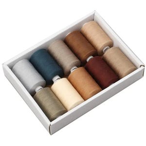 May include: A set of ten spools of sewing thread arranged in a white rectangular box. The thread colours include shades of light grey, dark blue, beige, tan, brown, dark red, and olive green, each wound onto a white plastic cylindrical core.