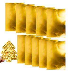 May include: A collection of gold-colored, rectangular gift bags arranged with a gold Christmas tree ornament. The ornament is shaped like a Christmas tree and is decorated with colorful gems. The bags have a shiny, metallic finish.