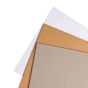 May include: A stack of three sheets of paper in different colors: white, tan, and gray. The sheets are layered, with the white sheet on top, followed by the tan sheet, and the gray sheet at the bottom. The paper is clean and smooth.
