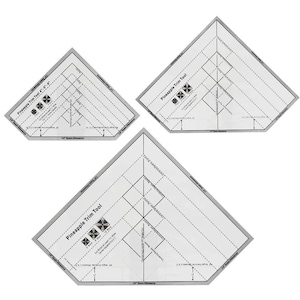 May include: Three clear plastic Pineapple Trim Tools with gray borders. Each tool has dotted lines and text for quilting measurements. The text "Pineapple Trim Tool" is printed on each tool. The tools are designed for quilting.