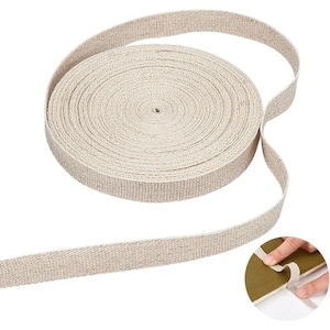 May include: A roll of beige canvas webbing, suitable for various craft and DIY applications. The webbing is tightly woven and appears durable, with a visible texture. The roll is circular, with a length of webbing extending from the centre.
