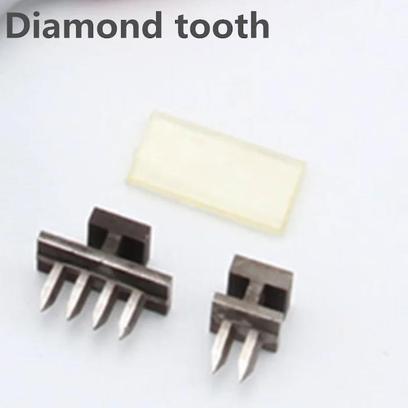 May include: Two metal tools with diamond-shaped teeth. The tool on the left has five teeth and the tool on the right has two teeth. Both tools have a black base.