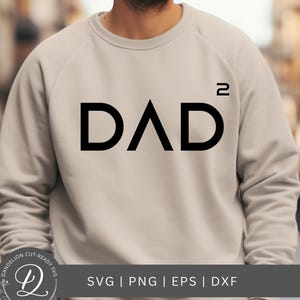 May include: A beige sweatshirt with the word "DAD²" printed in black. The design features the word "DAD" with a triangle in place of the "A", and a superscript "2". The bottom of the image has the text "SVG | PNG | EPS | DXF".