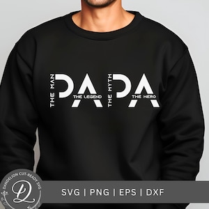 Puede incluir: Sudadera negra con la palabra "PAPA" en letras blancas grandes. Las palabras "THE MAN", "THE LEGEND", "THE MYTH" y "THE HERO" también están impresas en blanco. La parte inferior de la imagen tiene el texto "SVG | PNG | EPS | DXF".