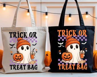May include: Two Halloween-themed tote bags. One is off-white, the other black. Each features a ghost wearing an orange beanie, holding a pumpkin and a drink. The text "TRICK OR TREAT BAG" is displayed on each bag.