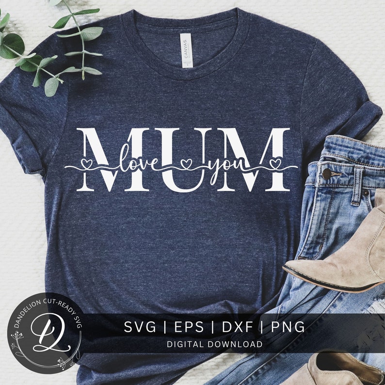 May include: A navy blue t-shirt with the text "MUM love you" in white with two small hearts on either side of the word "love". The shirt is laying on a white surface with a pair of blue jeans and brown boots.