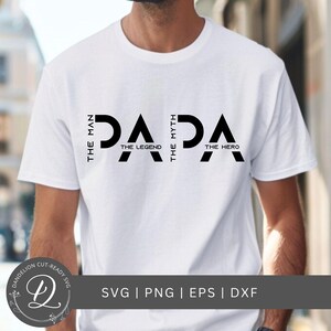 May include: White t-shirt with the word "PAPA" in bold black letters. The text is accompanied by the phrases "The Man, The Legend, The Myth, The Hero". The shirt also includes the text "SVG | PNG | EPS | DXF".
