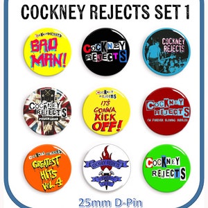 May include: Nine 25mm diameter button badges featuring various designs related to the band Cockney Rejects. The badges feature a mix of colors, including red, yellow, blue, green, black, and white. The text on the badges includes "Cockney Rejects", "Bad Man", "Power Grab", "It's Gonna Kick Off", "Greatest Hits Vol. 4", "I'm Forever Blowing Bubbles", and "The Power of Gerry".