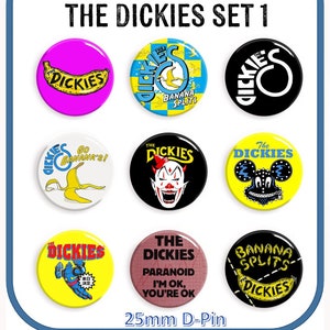 May include: Nine 25mm diameter pinback buttons featuring various designs from the band The Dickies. The buttons feature a variety of colors, including yellow, black, white, red, blue, pink, and brown. The buttons feature images of a banana, a clown, a mouse, a cartoon character, and text.