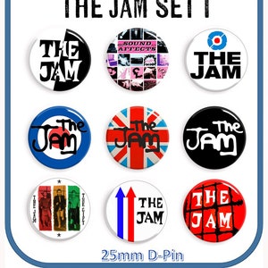 May include: Set of nine 25mm The Jam band pin badges. The badges feature various designs including the band's logo, a Union Jack flag, and a target symbol. The text "The Jam" appears on all of the badges.