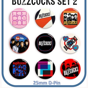 May include: Nine 25mm diameter pinback buttons featuring various designs from the band Buzzcocks. The designs include a black and white photo of the band, a red and white geometric design, a black and white photo of the band with the words "love bites", a black and white photo of the band with the words "Buzzcocks", a red and white geometric design, a red and white design with two hearts, a black and white photo of the band with the words "Buzzcocks", a red and white geometric design, and a red and white design with the words "Buzzcocks".