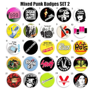 Puede incluir: Un conjunto de 25 insignias punk variadas, cada una con un diseño y texto únicos. Las insignias presentan nombres de bandas, logotipos y gráficos en una variedad de colores, incluyendo negro, blanco, amarillo y rojo. El texto "Mixed Punk Badges SET 2" está en la parte superior.