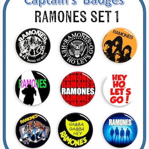 May include: A set of nine Ramones band badges with various designs. The badges feature the band's name, album art, and phrases like "Hey Ho Let's Go!" and "Gabba Gabba Hey." The badges are round and colorful.
