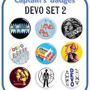 May include: Nine round button badges featuring various images and text related to the band Devo. The badges feature images of the band members, album covers, and tour dates. The text on the badges includes "DE-EVOLUTION", "DEVO", "ARE WE NOT MEN", and "DEVO LIVE 2021".