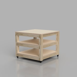 May include: A wooden shelf unit with three shelves and wheels. The shelf unit is made of light wood and has a natural finish.