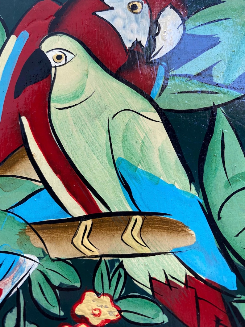 May include: A painting of two parrots perched on a branch. The parrot on the left is green with blue wings and a yellow beak. The parrot on the right is red with blue wings and a white head. The background is a dark green with leaves and flowers.