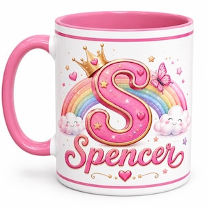 May include: A white ceramic mug with a pink handle and interior rim. The design features a large pink letter S topped with a gold crown, a colorful rainbow, two smiling clouds, a pink butterfly, small stars, hearts, and the name Spencer in pink.