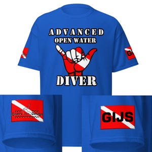 May include: Royal blue t-shirt with the words "ADVANCED OPEN WATER DIVER" in white block letters. The shirt features a red and white hand gesture graphic. Small red and white patches are on the sleeves.