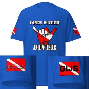 May include: Royal blue t-shirt with the words "OPEN WATER DIVER" and a red, white, and black hand gesture graphic. The left sleeve has a red square with a white diver graphic and the words "Divers Design". The right sleeve has a red square with the letters "GIJS".