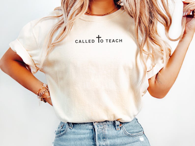 May include: A white t-shirt with the text "CALLED TO TEACH" and a cross symbol.