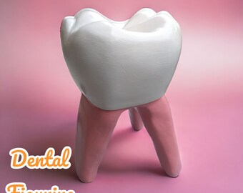 May include: A white ceramic tooth figurine with pink legs. The figurine is a decorative object for a dentist's surgery or a child's room.