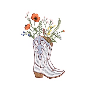 May include: White cowboy boots with a blue denim lining filled with a bouquet of colourful wildflowers, including red poppies, yellow and white flowers, and green foliage.
