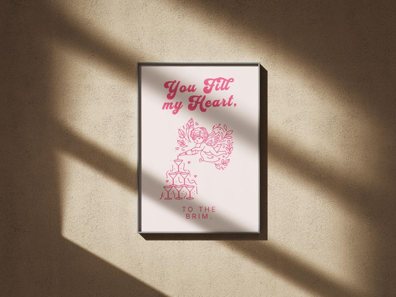 May include: A pink and white print with a heart design and the text "You fill my heart, to the brim."