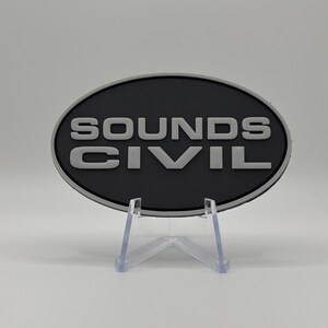 May include: A black oval patch with the words "SOUNDS CIVIL" in white raised lettering.