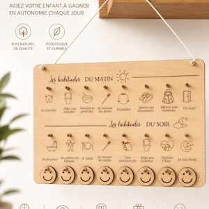 Puede incluir: Tablero de rutinas Montessori de madera con el texto "TABLEAU ROUTINES MONTESSORI". Presenta iconos de hábitos matutinos y vespertinos, fichas de caritas sonrientes y texto en francés. El tablero está diseñado para ayudar a los niños a ganar autonomía.