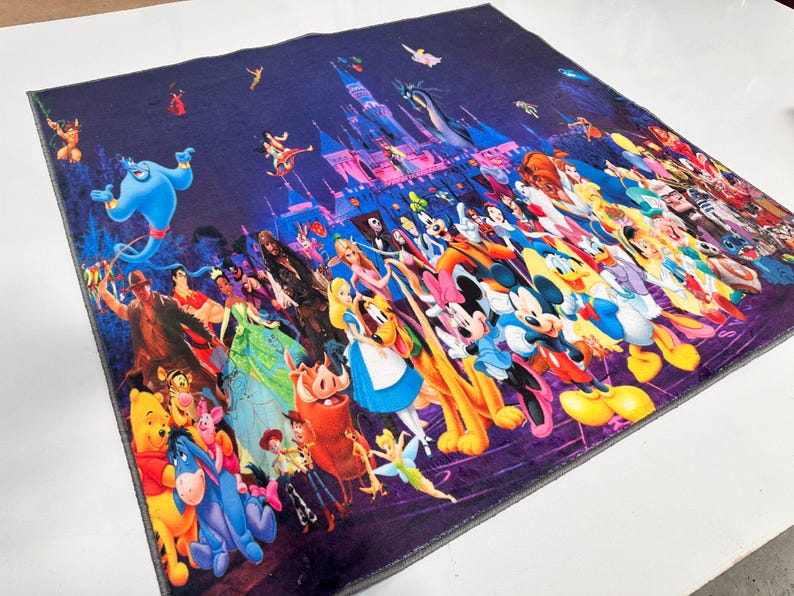 May include: A square, dark purple blanket featuring a vibrant collage of Disney characters. The design includes Cinderella's castle, Genie, Mickey Mouse, and many other beloved characters from various Disney movies. The blanket is likely made of soft fabric.