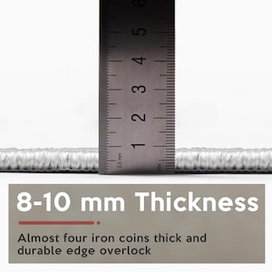 May include: A close-up of a light grey rug with a ruler indicating a thickness of 8-10 mm. The image text states "8-10 mm Thickness" and "Almost four iron coins thick and durable edge overlock."