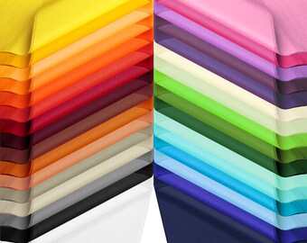 May include: A stack of colorful tissue paper in various shades of yellow, orange, red, brown, beige, gray, black, white, pink, purple, cream, green, blue, and navy. The tissue paper is arranged in a fan shape, with the colors alternating.