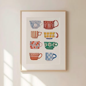 May include: A framed print of a watercolour illustration of eight colourful teacups with various patterns. The teacups are arranged in three rows, with the top row having two teacups, the middle row having three teacups, and the bottom row having three teacups.