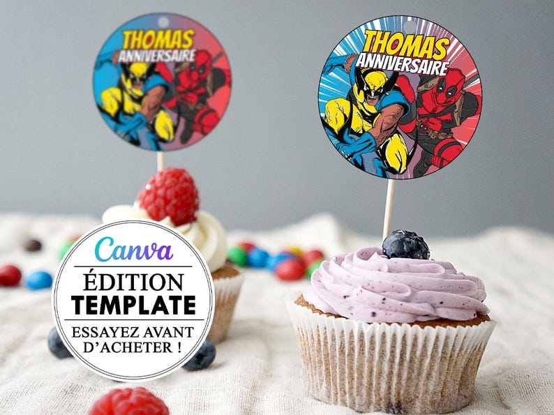May include: Two cupcake toppers featuring Wolverine and Deadpool from Marvel Comics. The toppers are round and have a blue, red, and yellow color scheme. The text on the toppers reads "Thomas Anniversaire".
