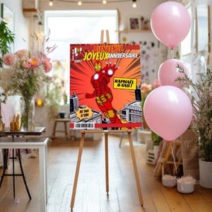 May include: A red and yellow comic book style birthday sign with an illustration of Iron Man flying. The sign says "Bienvenue Joyeux Anniversaire Raphael 8 ans!" and "De 14h a 18h".