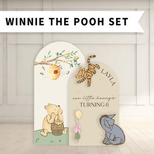 May include: A Winnie the Pooh themed set with illustrations of Pooh Bear, Tigger, Eeyore, and Piglet. The set includes a honey pot, a beehive, and the text "WINNIE THE POOH SET". The second panel says "our little hunny's TURNING 6" and the name "LAYLA".