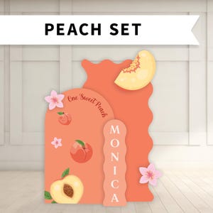 May include: A peach-themed set with the text "PEACH SET" at the top. The set features peach-colored cutouts with peach illustrations, floral accents, and the name "MONICA". The phrase "One Sweet Peach" is also included.