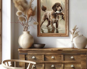 May include: A brown and white poodle dog stands in a shallow body of water, holding a duck in its mouth. The dog is looking at the camera. The background is a blurred image of trees and water.