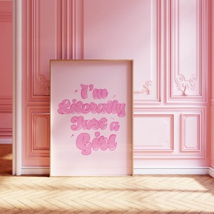 May include: A pink framed poster with the text "I'm Literally Just a Girl" in a pink retro font.