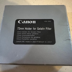 May include: A gray box with the Canon logo and the text "72mm Holder for Gelatin Filter" printed on it. The box also includes the text "CZ6-1563" and "CANON INC. Made in Japan/Fabriqué au Japon".