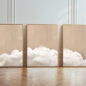 Puede incluir: Tres impresiones sobre lienzo enmarcadas con un fondo beige y nubes blancas en la parte inferior de cada impresión.