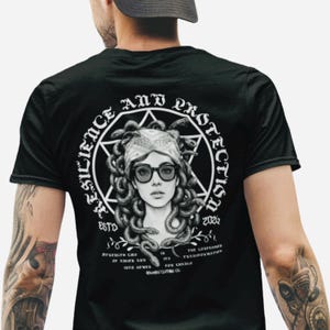 May include: A white ceramic mug with a black handle and the text "But First, Coffee" in a black, handwritten-style font. The mug is on a white surface.