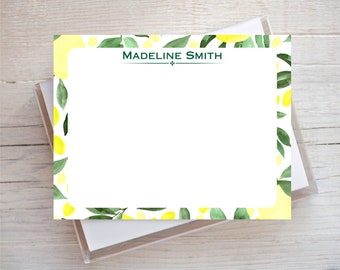 May include: A white notepad with a lemon and leaf border. The notepad has a green header with the name "MADELINE SMITH" printed in white.