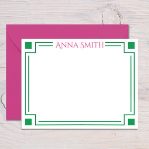 May include: White stationery card with a green border and the name "ANNA SMITH" printed in pink.