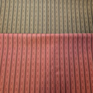 May include: A textile fabric featuring two distinct horizontal sections. The top section is a taupe-colored fabric with vertical stripes of dark brown and white. The bottom section is a rose-pink fabric with identical vertical stripes of dark brown and white.