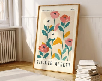 May include: A framed poster with a floral design. The poster features a light beige background with stylized flowers in shades of pink, white, and green. The text "SERIE BOTANIQUE NO. 021" and "FLOWER MARKET" are printed on the poster.