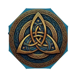 May include: A blue umbrella featuring a gold and blue Celtic knot design. The intricate knotwork is centered on the umbrella's canopy, surrounded by a circular border of interwoven patterns. The umbrella's background is a solid blue color.