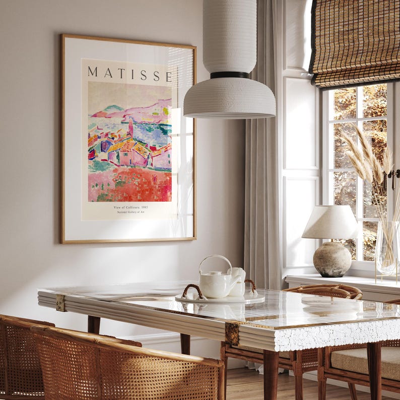 May include: A framed poster with a painting of a colorful landscape with houses and a blue sky. The poster is titled "MATISSE" and has the text "View of Collioure, 1905" and "Henri Matisse, father of art".