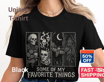May include: Black unisex t-shirt with a graphic design featuring a skeleton, skulls, a moth, and a haunted house. The text "SOME OF MY FAVORITE THINGS" is printed below the images.