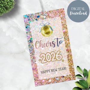May include: A glittery gift tag with a festive design. The tag features the words "Cheers to 2026" and "Happy New Year!" in a decorative font, along with a golden ornament illustration. The tag is a digital download.